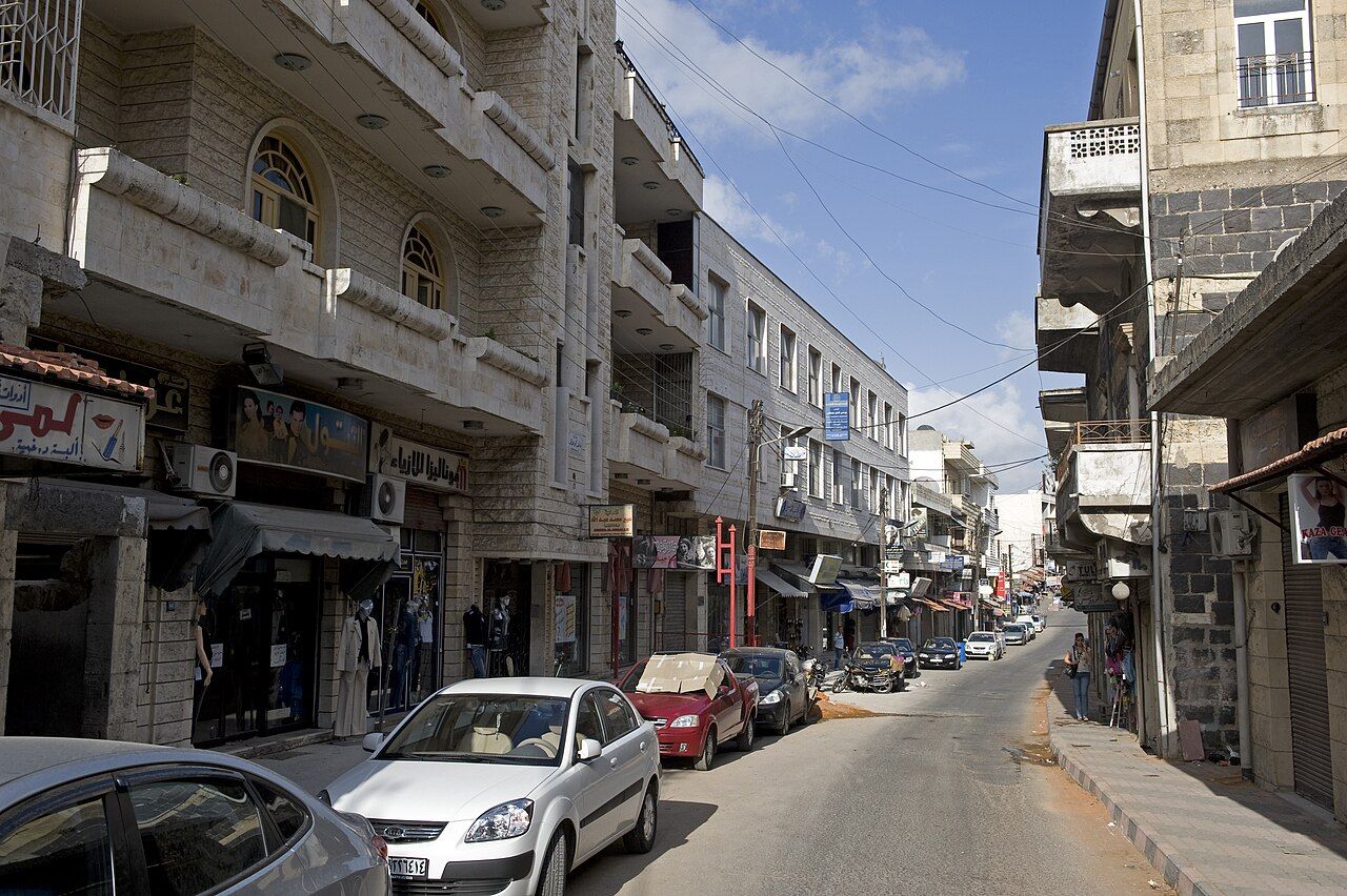 Safita, Tartus Governorate — A white Crusader tower above green coastal hills